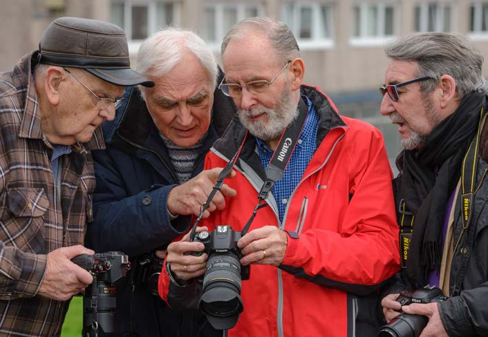 Photographers looking at image on digital camera screen